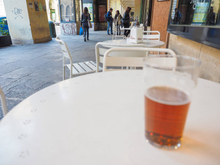 TURIN, ITALY - OCTOBER 22, 2014: Pint of British ale on a pub table - selective focus on people in the backgroundのeditorial素材