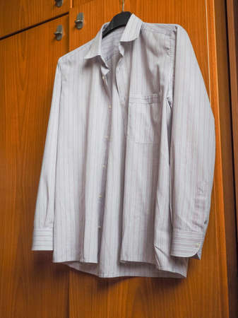 Mans formal shirt on a clothes hangerの写真素材