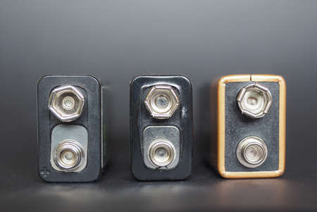 three 9v batteries over blackの写真素材