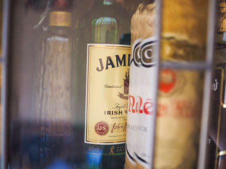 BERLIN, GERMANY - FEBRUARY 10, 2015: Bottles of spirits in a bar glass case, including Jamesson Whiskey and Nega Fulo Cachacaのeditorial素材