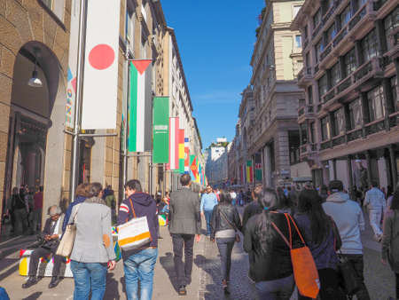 MILAN, ITALY - MARCH 28, 2015: Tourists walking by the flags from all countries of the world on show in Milan city centre as part of the Expo Milano 2015 international exhibitionのeditorial素材