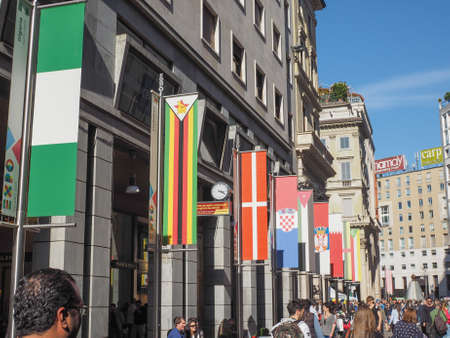 MILAN, ITALY - MARCH 28, 2015: Tourists walking by the flags from all countries of the world on show in Milan city centre as part of the Expo Milano 2015 international exhibitionのeditorial素材