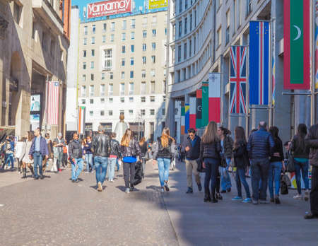 MILAN, ITALY - MARCH 28, 2015: Tourists walking by the flags from all countries of the world on show in Milan city centre as part of the Expo Milano 2015 international exhibitionのeditorial素材