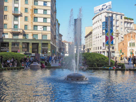 MILAN, ITALY - MARCH 28, 2015: Tourists by Piazza San Babila fountain in Milan city centreのeditorial素材