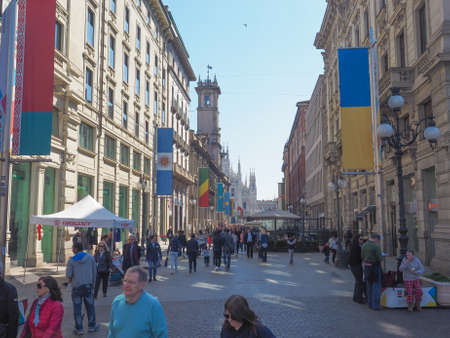 MILAN, ITALY - MARCH 28, 2015: Tourists walking by the flags from all countries of the world on show in Milan city centre as part of the Expo Milano 2015 international exhibitionのeditorial素材