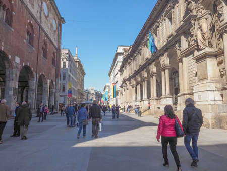MILAN, ITALY - MARCH 28, 2015: Tourists walking by the flags from all countries of the world on show in Milan city centre as part of the Expo Milano 2015 international exhibitionのeditorial素材