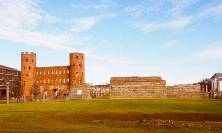 Vintage looking Palatine towers Porte Palatine ruins of ancient roman town gates and wall in Turinの写真素材