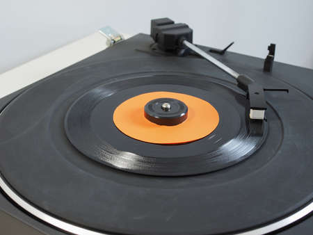 Vinyl record on a turntable record player, single 45rpm disc