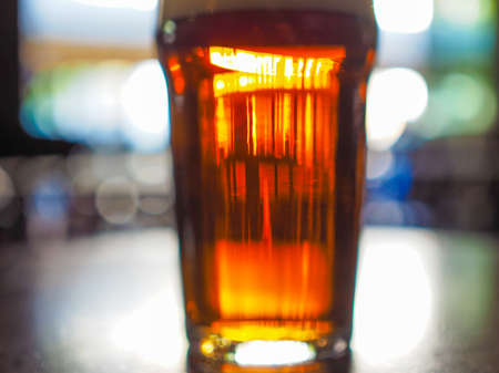 Abstract blurred image of a pint in a pubの写真素材