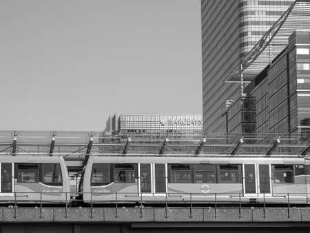 LONDON, UK - JUNE 11, 2015: The DLR meaning Docklands Light Railway links the docks redevelopment area in East London with the city centre in black and whiteのeditorial素材