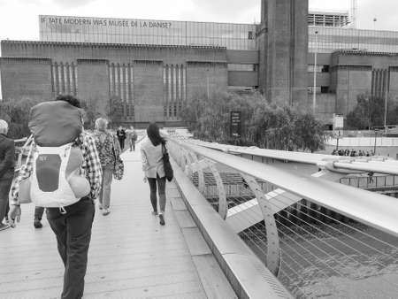 LONDON, UK - JUNE 10, 2015: People crossing the Millennium Bridge linking the City of London with the South Bank between St Paul Cathedral and Tate Modern art gallery in black and whiteのeditorial素材