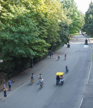 TURIN, ITALY - JULY 11, 2015: Tourists on a rickshaw in Parco del Valentino park