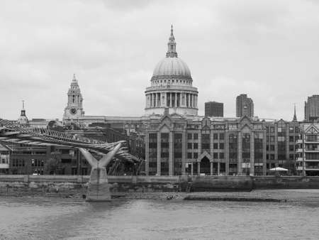 LONDON, UK - JUNE 10, 2015: People crossing the Millennium Bridge linking the City of London with the South Bank between St Paul Cathedral and Tate Modern art gallery in black and whiteのeditorial素材