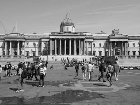 LONDON, UK - JUNE 11, 2015: Tourists visiting Trafalgar Square in front of the National Gallery in black and whiteのeditorial素材