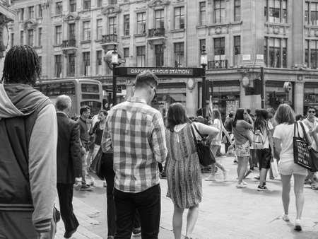 LONDON, UK - JUNE 12, 2015: Travellers at Oxford Circus underground station in black and whiteのeditorial素材