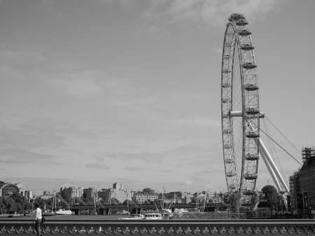 LONDON, UK - JUNE 10, 2015: The London Eye ferris wheel on the South Bank of River Thames aka Millennium Wheel built in 1999 using advanced aeronautical engineering know how by British Airways in black and whiteのeditorial素材