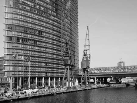 LONDON, UK - JUNE 11, 2015: The Canary Wharf business centre is the largest business district in the United Kingdom in black and whiteのeditorial素材