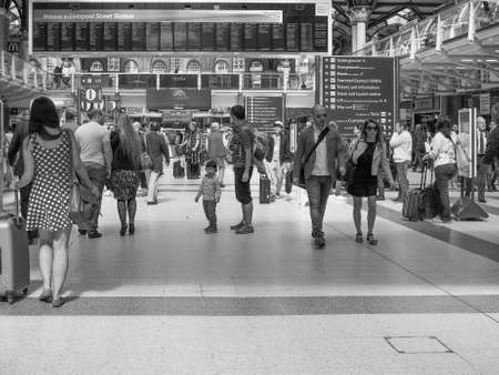 LONDON, UK - JUNE 12, 2015: Travellers at Liverpool Street Station in black and whiteのeditorial素材