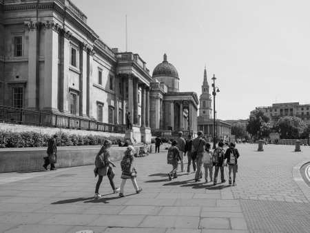 LONDON, UK - JUNE 11, 2015: Tourists visiting Trafalgar Square in front of the National Gallery in black and whiteのeditorial素材