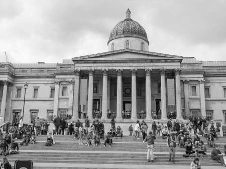 LONDON, UK - JUNE 09, 2015: Tourists visiting Trafalgar Square in front of the National Gallery in black and whiteのeditorial素材