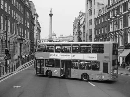 LONDON, UK - JUNE 12, 2015: Red double decker buses are a traditional landmark of London in black and whiteのeditorial素材