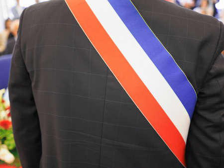 Mayor of French town with French tricolour flag mayoral sashの写真素材
