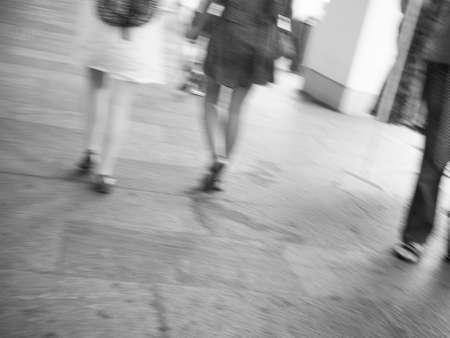 Women walking motion blur useful as blurred background in black and white