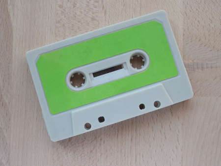 Magnetic tape cassette for analog audio music recording on a wooden tableの写真素材