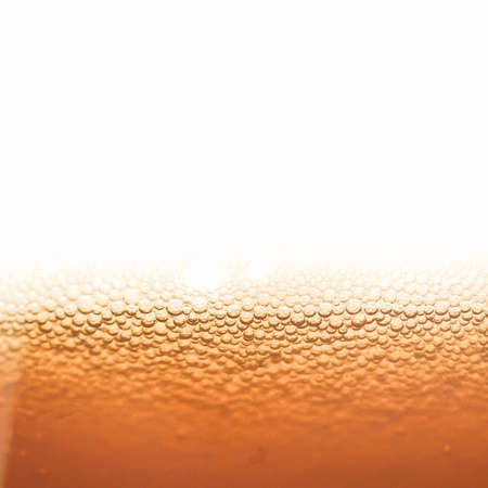 Vintage looking Beer foam in a glass, with copy spaceの写真素材