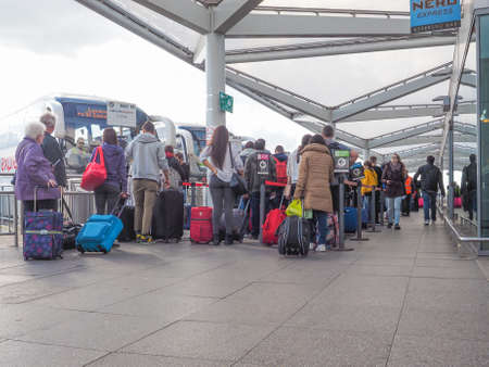 STANSTED, UK - SEPTEMBER 24, 2015: Travellers waiting for tranport at London Stansted airport coach stationのeditorial素材