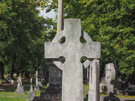 Graves and crosses and stones at old gothic cemetery in London, UKの写真素材