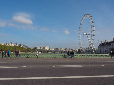 LONDON, UK - SEPTEMBER 28, 2015: The London Eye ferris wheel on the South Bank of River Thames aka Millennium Wheel seen from Westminster Bridgeのeditorial素材