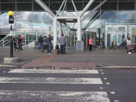 STANSTED, UK - SEPTEMBER 24, 2015: Travellers in front of London Stansted airport design by architect Lord Norman Fosterのeditorial素材