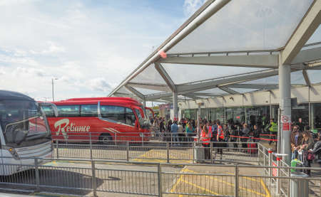 STANSTED, UK - SEPTEMBER 24, 2015: Travellers waiting for tranport at London Stansted airport coach...