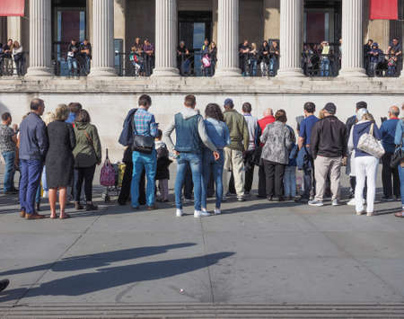 LONDON, UK - SEPTEMBER 27, 2015: Tourists in Trafalgar Square in front of the National Galleryのeditorial素材