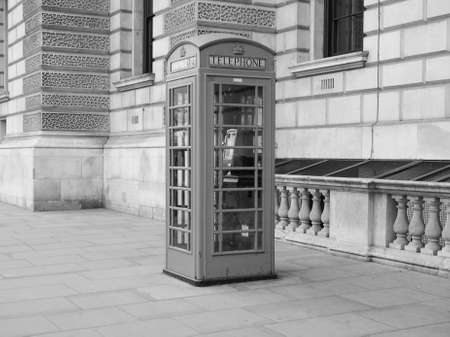 Traditional red telephone box in London, UK in black and whiteの写真素材