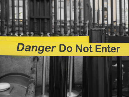 Yellow band fence danger do not enter warning signの写真素材