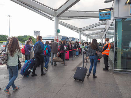 STANSTED, UK - SEPTEMBER 24, 2015: Travellers waiting for tranport at London Stansted airport coach stationのeditorial素材