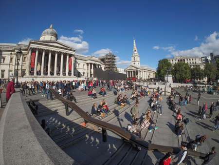 LONDON, UK - SEPTEMBER 27, 2015: Tourists in Trafalgar Square in front of the National Gallery