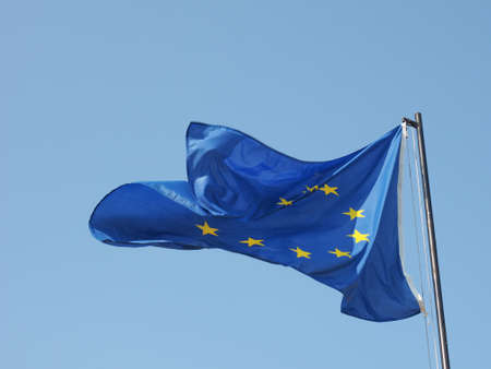 The national flag of European Union floating over blue skyの写真素材