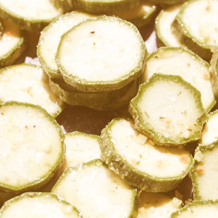 Vintage looking Green courgettes or zucchini vegetables useful as a backgroundの写真素材