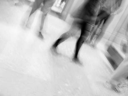Motion blur of people walking in a room in black and white