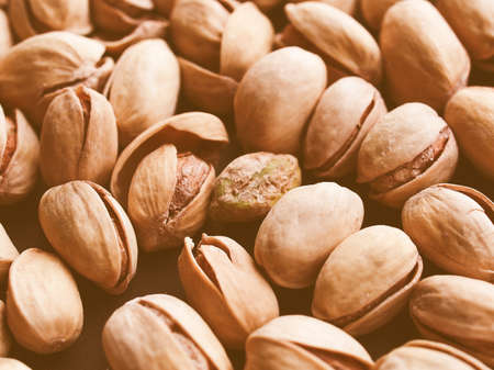 Vintage looking Food - Salted roasted pistachio nut with shell - useful as a backgroundの写真素材
