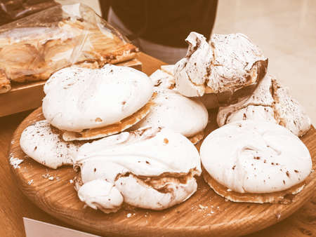 Vintage looking Meringues dessert on a wooden plateの写真素材