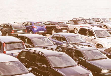 Car parking with many cars parked on the riverside vintage