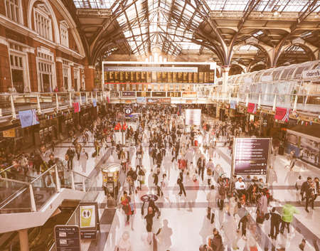 LONDON, UK - SEPTEMBER 28, 2015: Travellers at Liverpool Street Station multi exposure time lapse vintageのeditorial素材