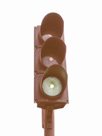 Green Traffic light semaphore isolated over white background vintage