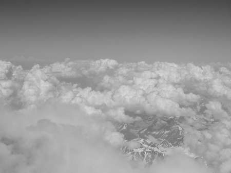 Aerial view of clouds over Alps mountains in black and whiteの写真素材