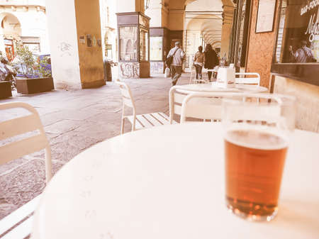 TURIN, ITALY - OCTOBER 22, 2014: Pint of British ale on a pub table - selective focus on people in the background vintageのeditorial素材