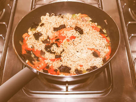 Vintage looking Curry noodles pasta traditional Indian and Japanese Asian food in a wok panの写真素材